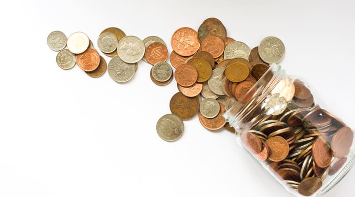 Jar of UK coins tipped over