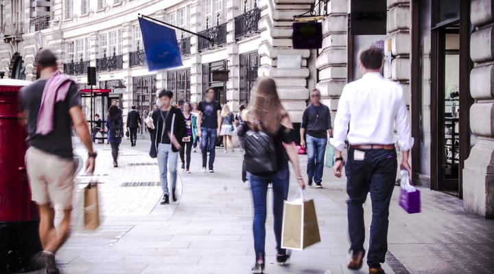 People walking down a busy shopping street in London