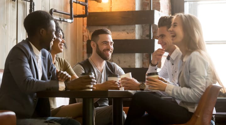 A group of young people enjoying a drink at a café.