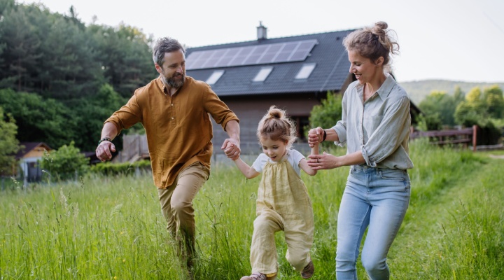 A young family playing in a garden.