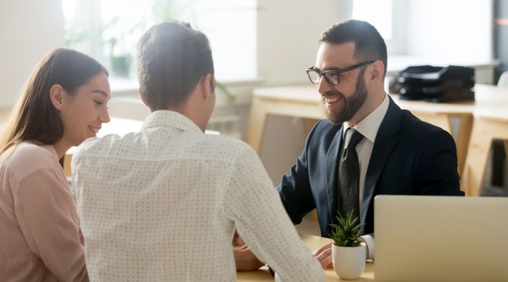 A young couple meeting with a financial planner.