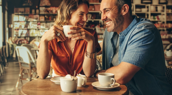 A couple laughing in a café.